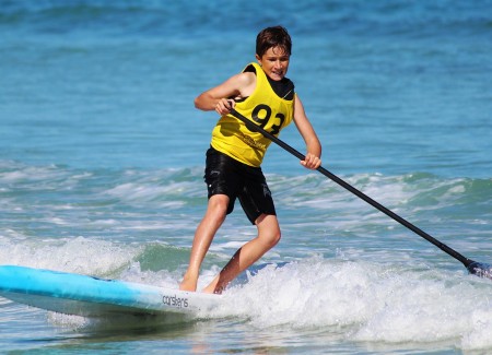 A boy riding on a surfing board